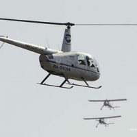Helicopter flying with planes R44  © Aleksander Markin 2012